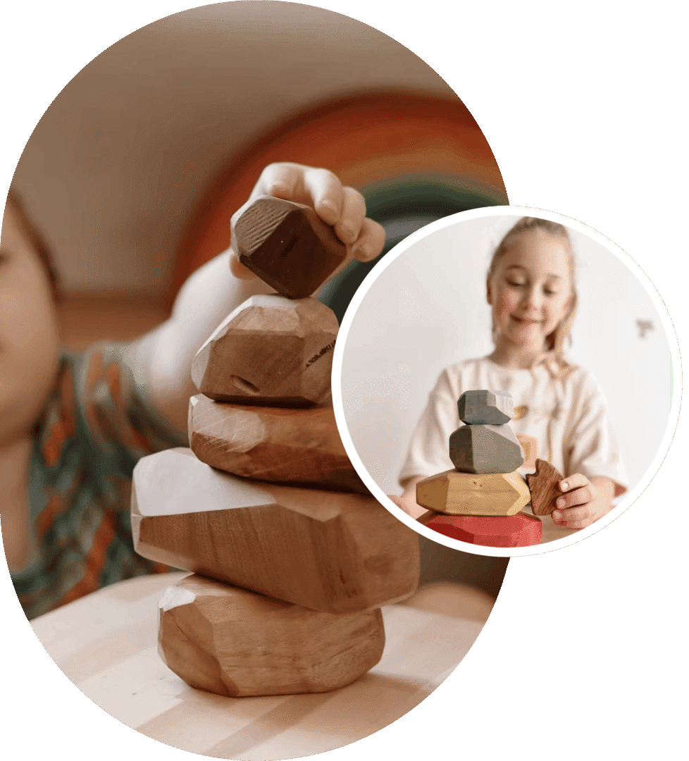 Children playing a wooden stacking block game, focusing on balancing blocks carefully.