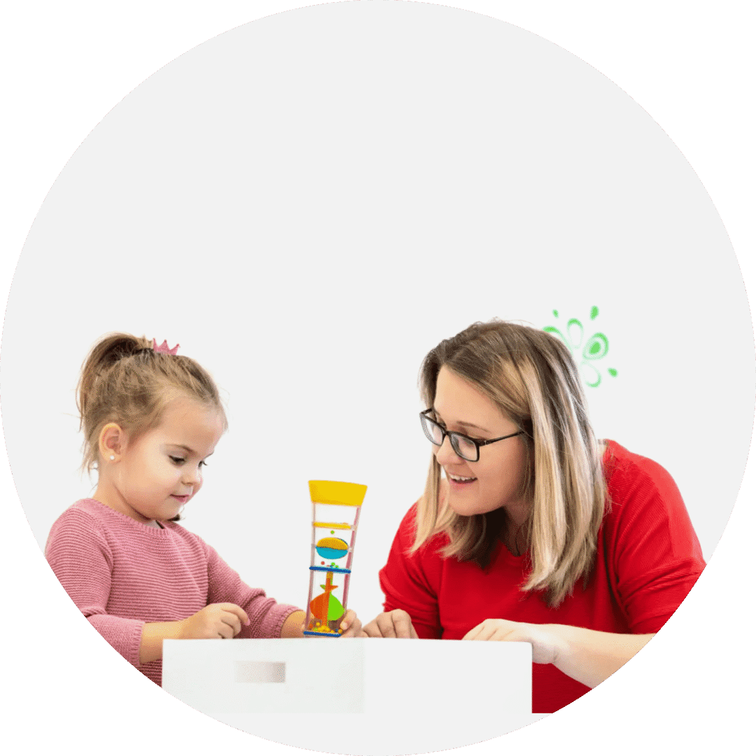 A young girl and a woman playing a game together at a white table with a simple white background.